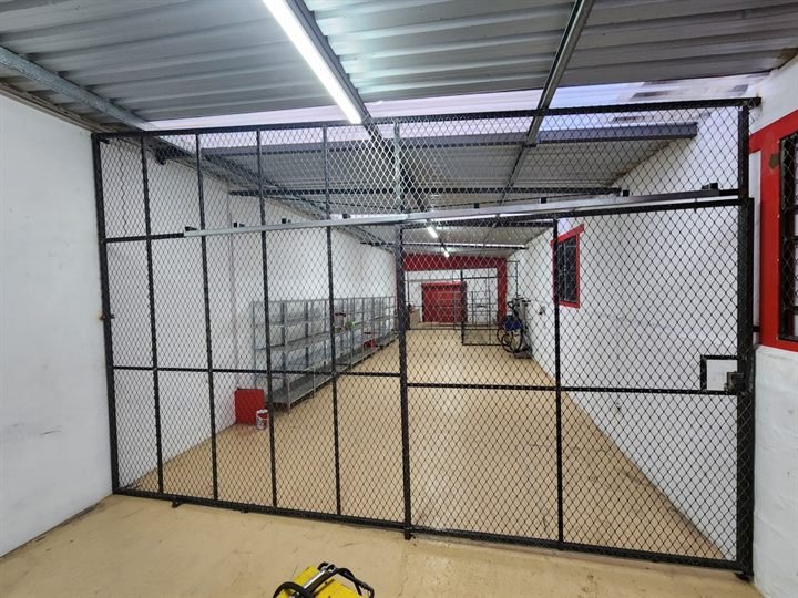 Internal welded mesh security partition with a lockable gate