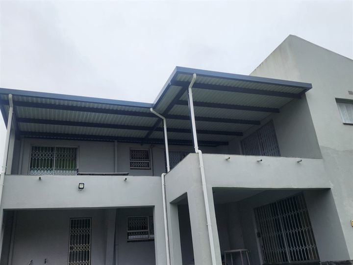 Steel-framed covered patio roof attached to a house
